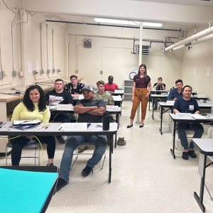 Business coach with a student in a classroom for Square One course.