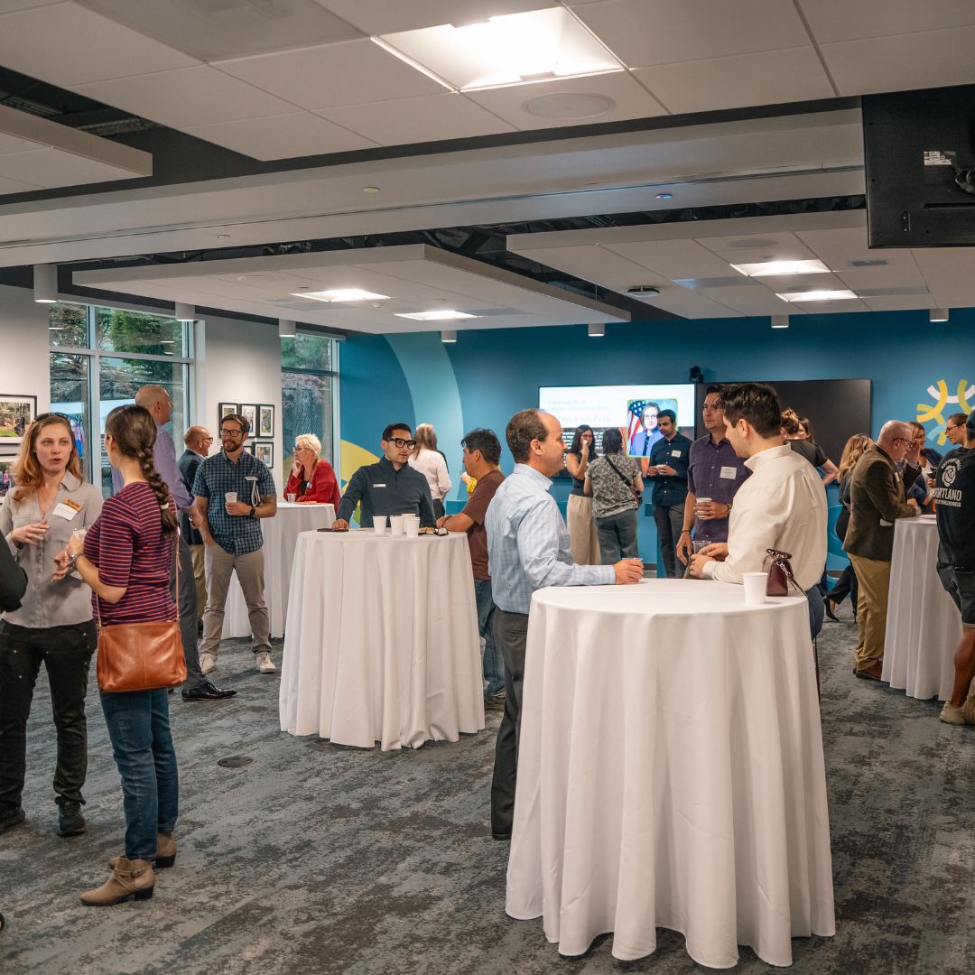 Attendees gather around tables and talk during Oregon Small Business Connections at the Unitus Business Center.