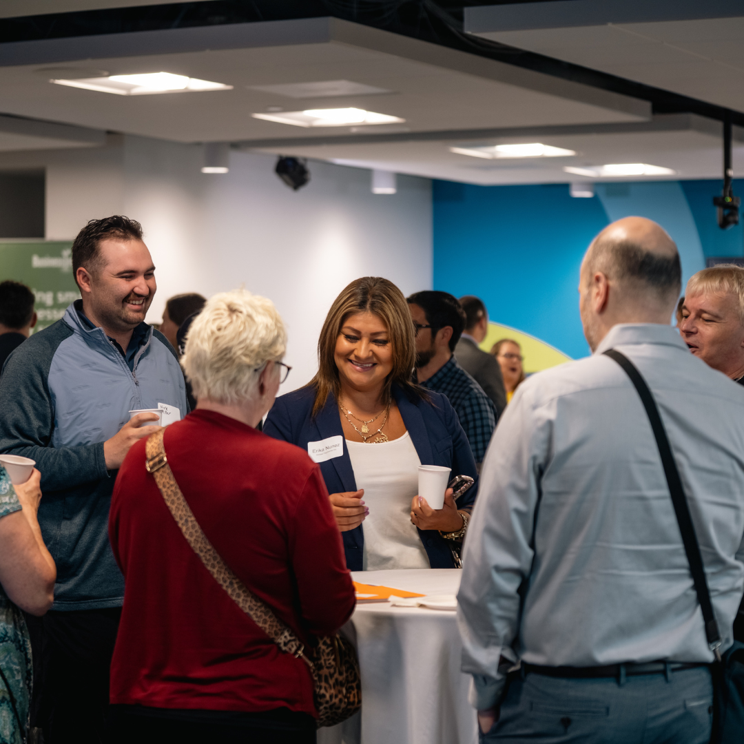 Attendees gather in conversation around a table during Oregon Small Business Connections.