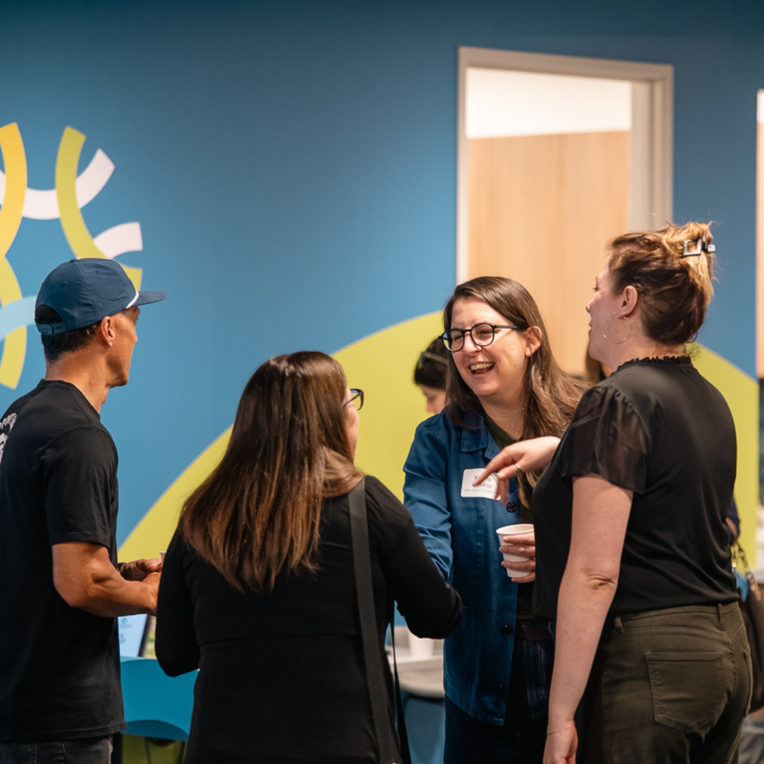 Attendees talk and laugh during Oregon Small Business Connections at the Unitus Business Center in Tigard.
