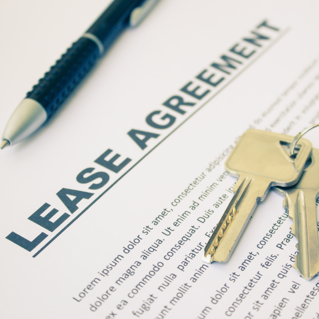 Lease agreement with keys and a pen, representing a commercial lease for a small business