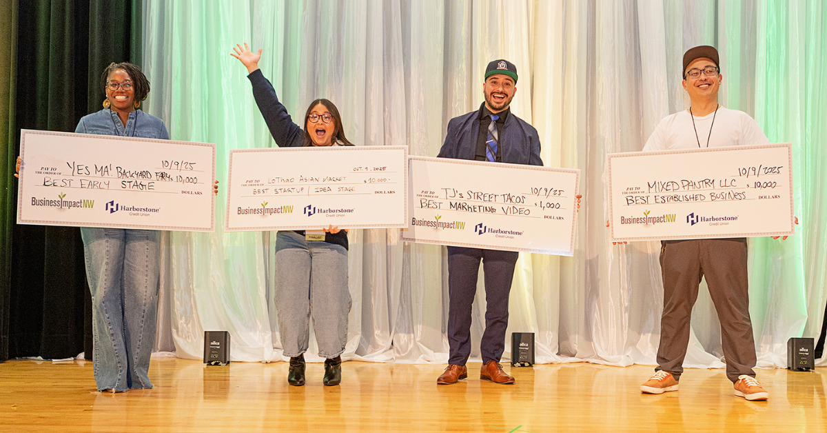 Four IMPACT Pitch winners celebrate onstage while holding oversized award checks for Best Early Stage, Best Startup, Best Marketing Video, and Best Established Business.