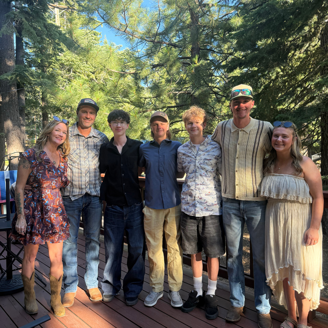 Seven members of the MCF Window Cleaning family posing together outdoors.