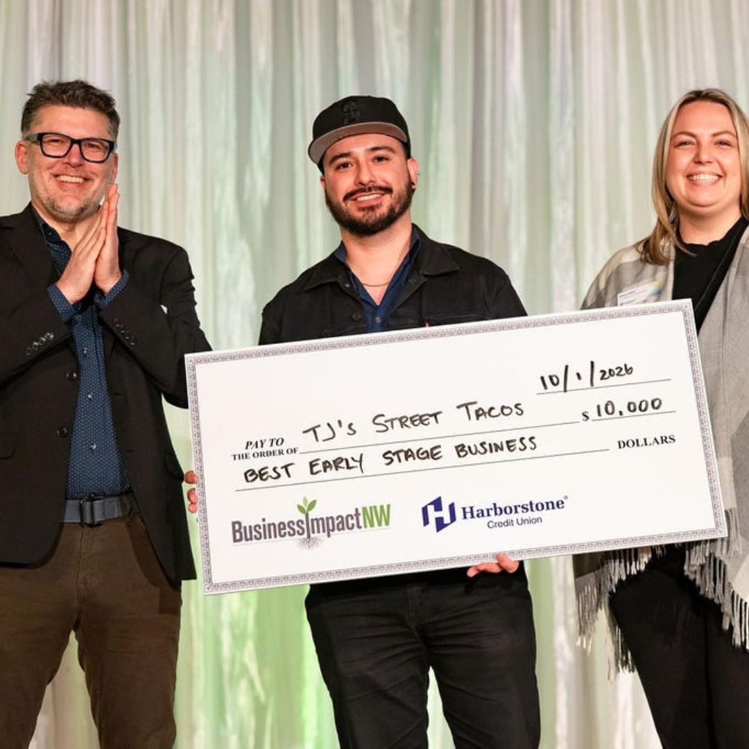 Pablo Vazquez of TJ’s Street Tacos holds a $10,000 Early Stage award check after winning IMPACT Pitch 2026.