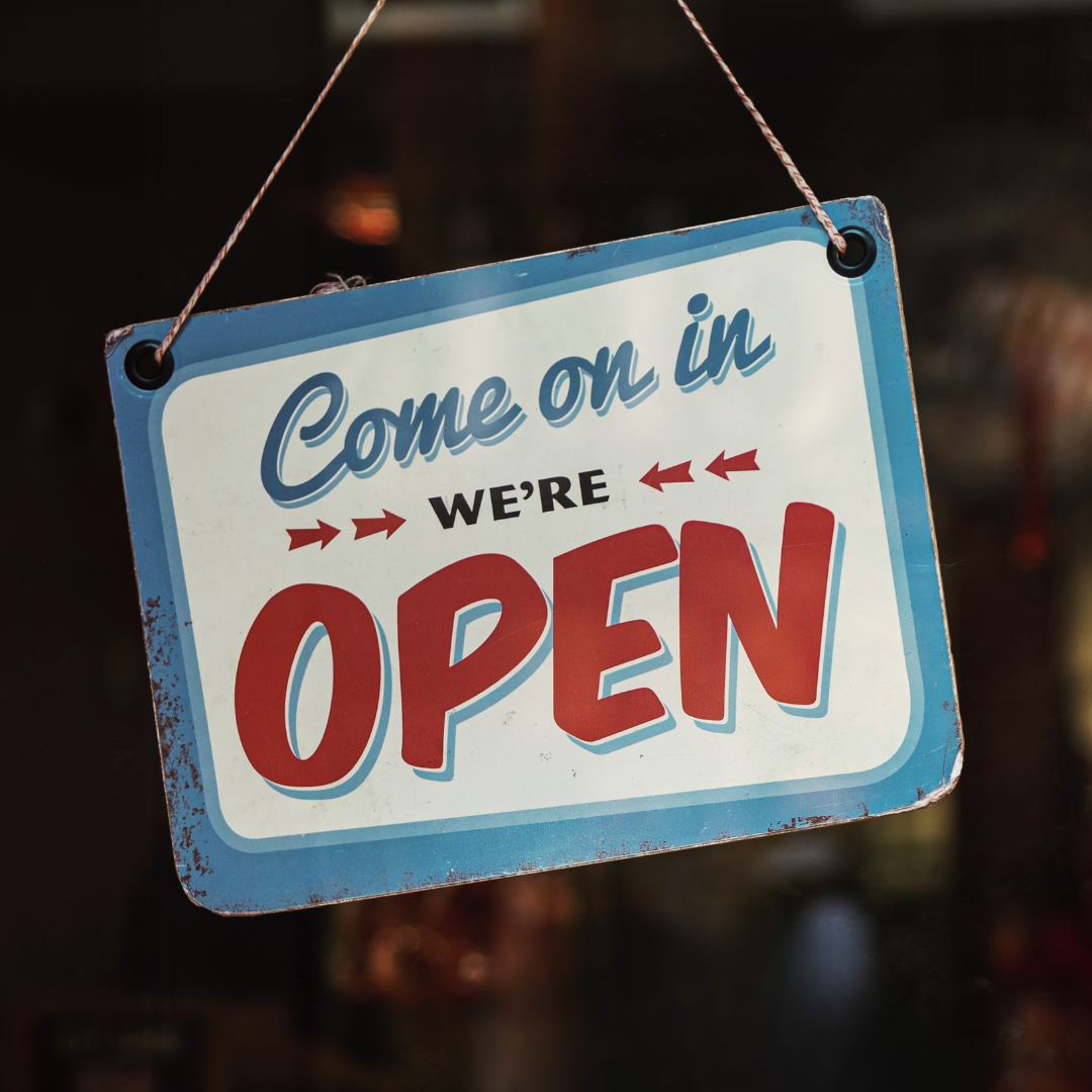 Hanging sign reading “Come on in, we’re open.”