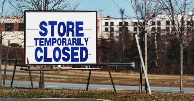 Large sign reading “Store Temporarily Closed” outside a business area.
